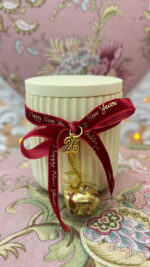 Yellow handmade scented candle with bell and velvet ribbon