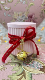 Pink handmade scented candle with bell and velvet ribbon