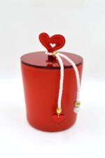 Candle in a red jar with a plexiglass heart lid Love
